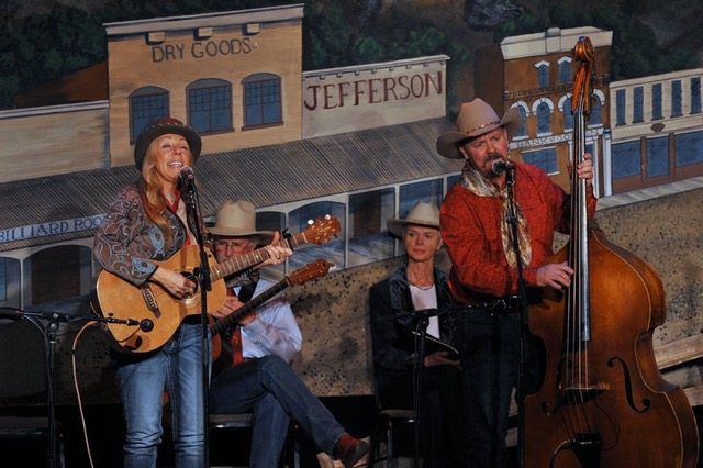 Pic of Eli Basi & John Cunningham performing Dave Stamey & Dorris Daley in background Colorado Cowboy Poetry Gathering Golden Colorado
